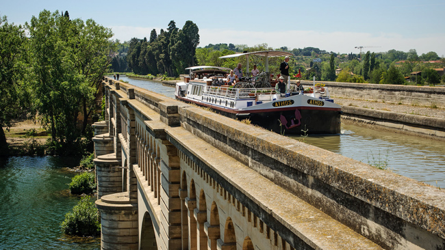 Barge Athos crossing the River Orb
