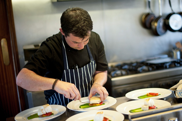 Chef preparing a meal on English Hotel Barge Magna Carta