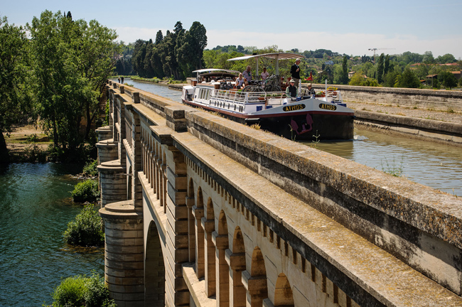 French Hotel Barge Athos crossing the aqueduct over the River Orb