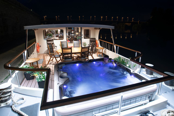 French Hotel Barge Grand Cru - forward deck with hot tub at night