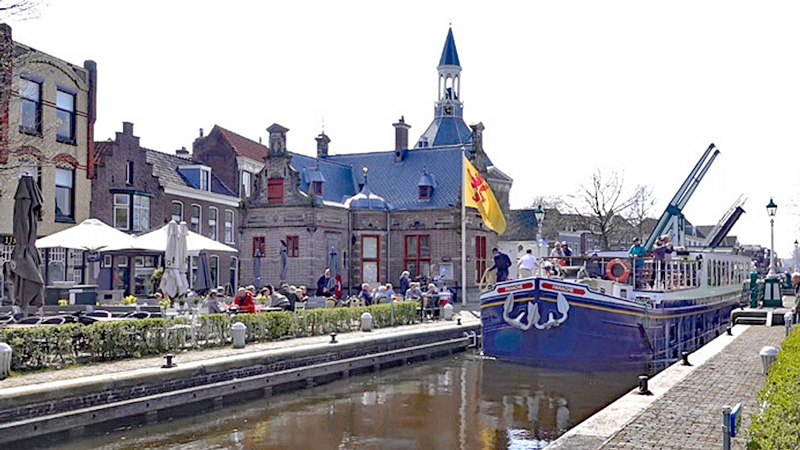 Hotel Barge Panache entering lock after bridge is raised in Holland town.