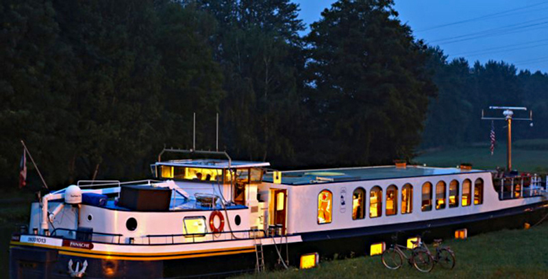 Luxury Hotel Barge Panache stopping for the night alongside the bank of the canal.