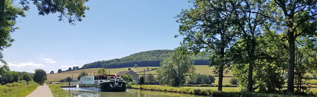 French Hotel Barge Prosperite crusing on the Canal du Bourgogne in Burgundy France
