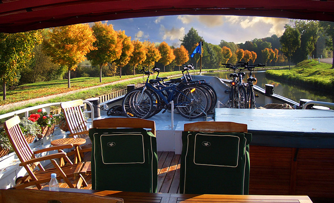 French Hotel Barge Prosperite - Sun deck with loungers, hot tub, and bicycles