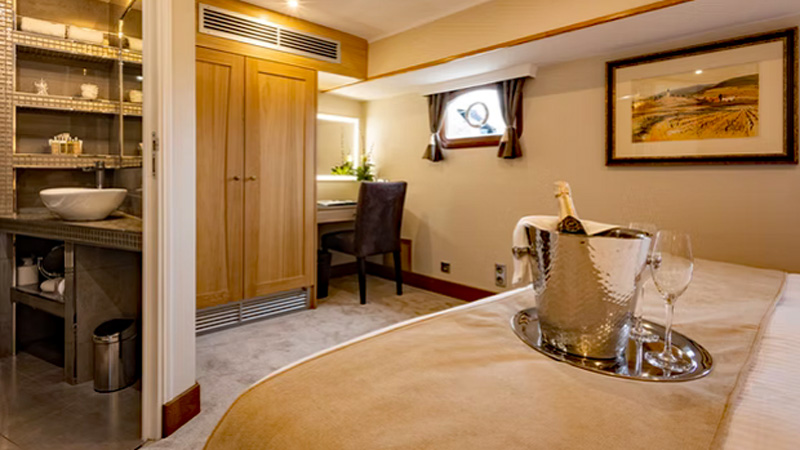 French Hotel Barge Rendez-Vous - Guest cabin. This photo shows a different view of thie stateroom: Entrance to private ensuite bathroom, clothes closet, desk