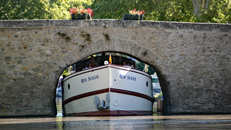 French Hotel Barge Roi Soleil on the Canal du Midi. The bridge at Le Somail is a tight fit