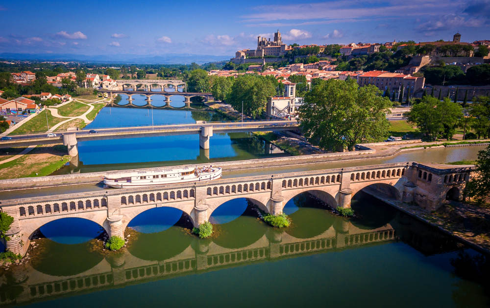 French Hotel Barge Roi Soleil on the Canal du Midi traversing the aqueduct over the Orb River at Béziers in the south of France