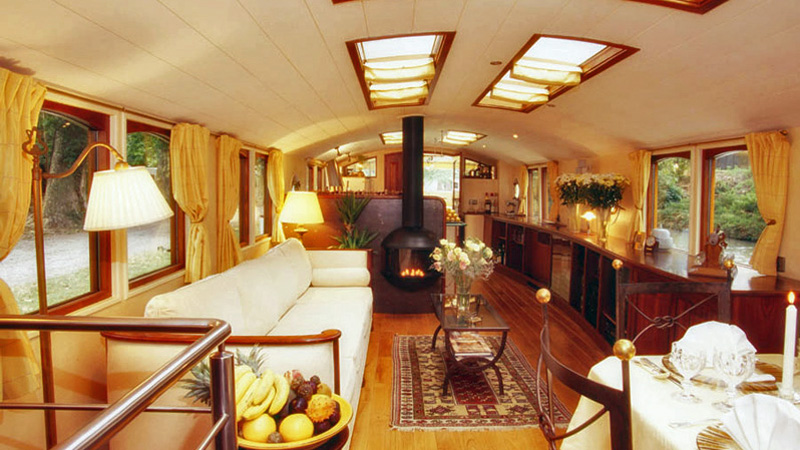 French Hotel Barge Roi Soleil - Salon with sofa and fireplace