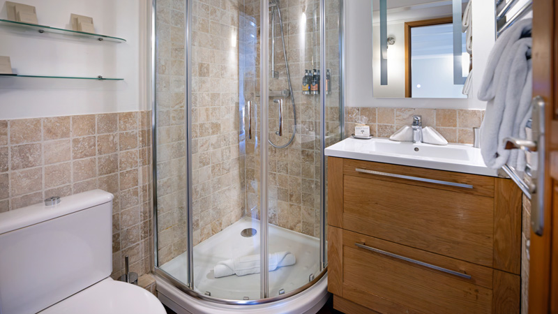 French Hotel Barge Enchante - Guest cabin's private, ensuite bathroom with toilet, shower, sink/vanity
