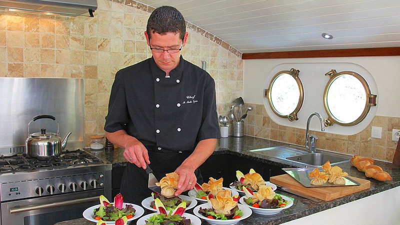 Chef preparing for a meal in French Hotel Barge Enchante's demonstration galley.
