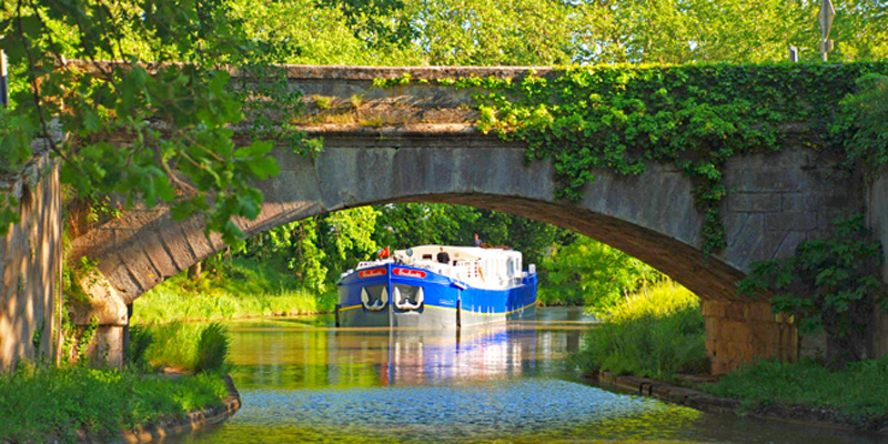 French Hotel Barge Enchante - Approaching a very pretty, low bridge on the Canal du Midi in the south of France