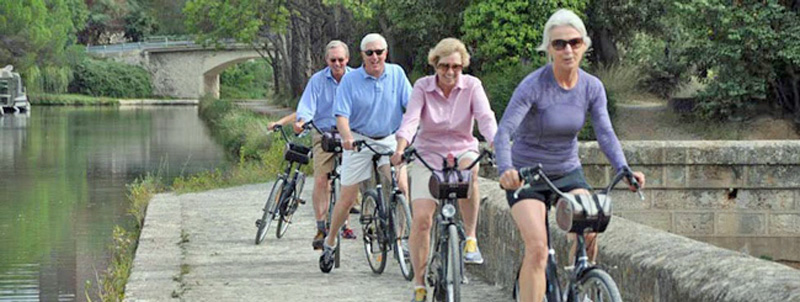 French Hotel Barge Enchante - Guests taking a bike ride along the Canal du Midi in the south of France