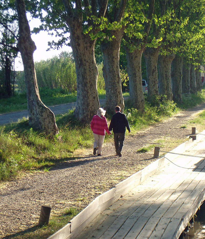 French Hotel Barge Enchante Guests - Couple taking a walk along the tow path
