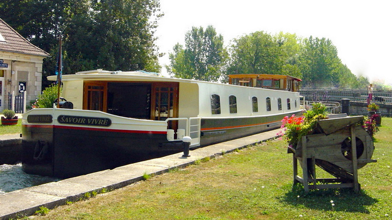French Hotel Barge Savoir Vivre in a lock on the Canal du Bourgogne, France