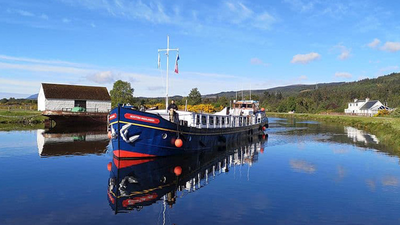 Scottish Hotel Barge Scottish Highlander cruising in a beautiful pastoral setting