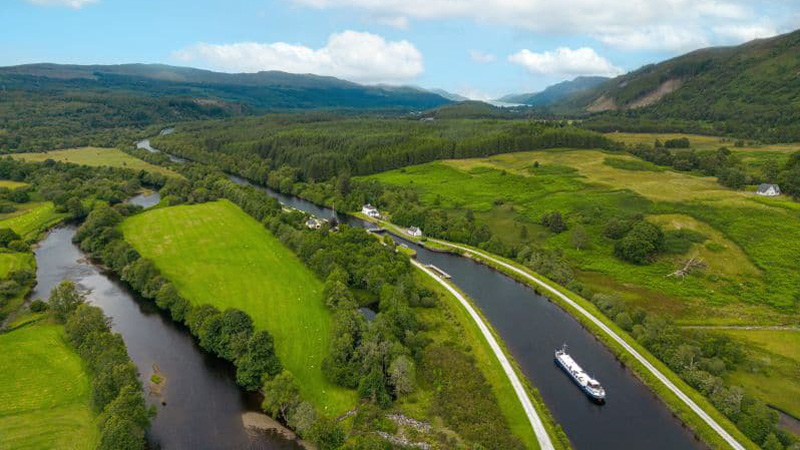 Scottish Hotel Barge Scottish Highlander cruising towards a lock