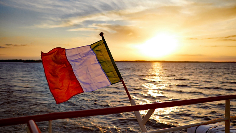 Irish Hotel Barge Shannon Princess flying her national tricolor ensign of green, white, and orange