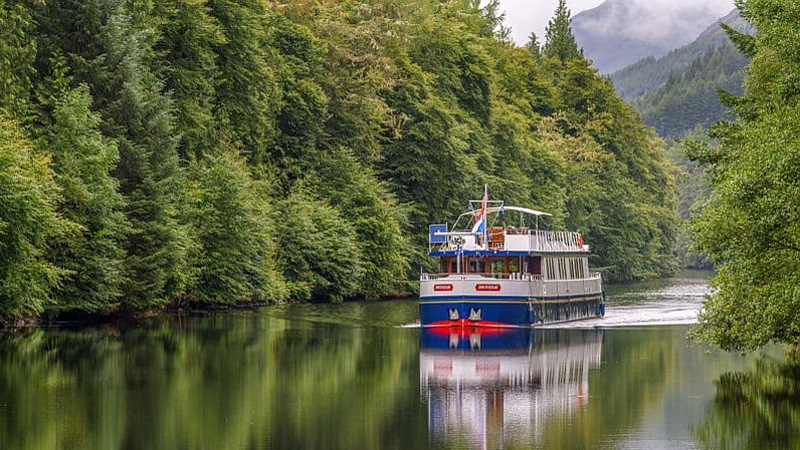 Scottish Hotel Barge Spirit of Scotland - Serene photo with glass-like water as the Spirit of Scotland cruises by