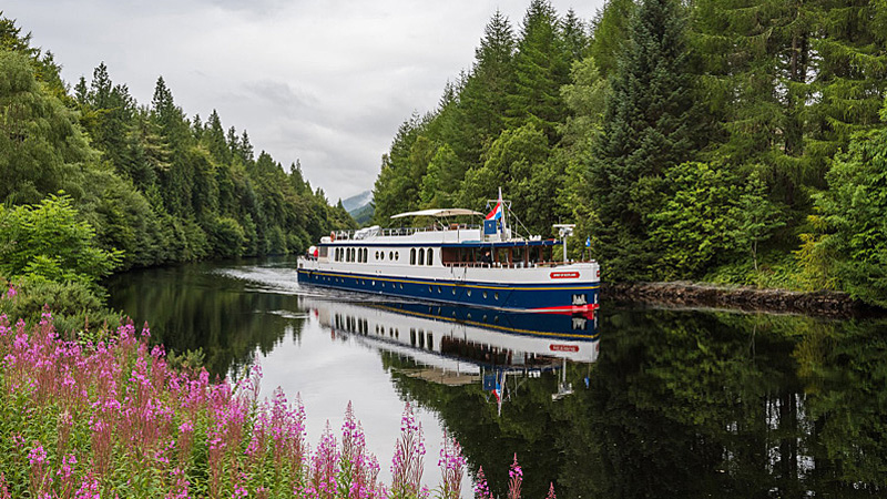 Scottish Hotel Barge Spirit of Scotland cruises in the Scottish Highlands - Pretty photo with flowers on the bank of the canal