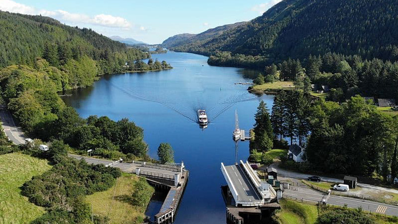 Scottish Hotel Barge Spirit of Scotland -approaching an open swing bridge with stopped traffic