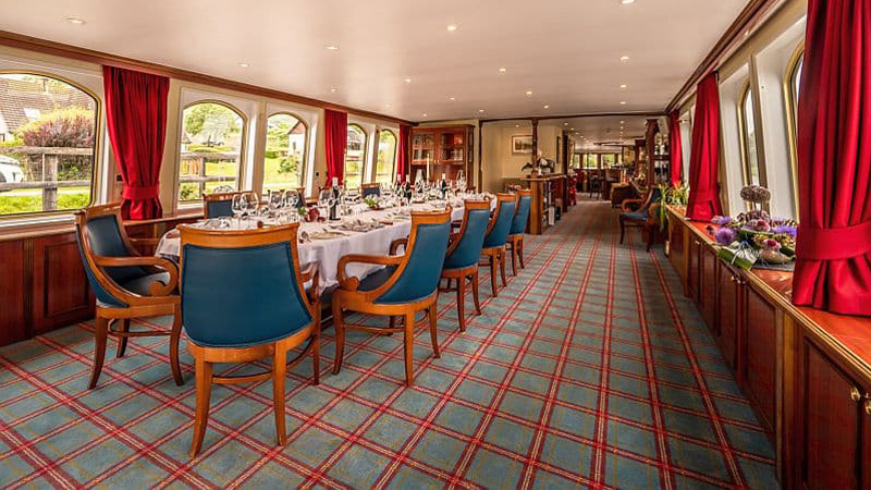Scottish Hotel Barge Spirit of Scotland - Dining table is set and ready to go. Panoramic windows adds to the spaciousness of the dining area