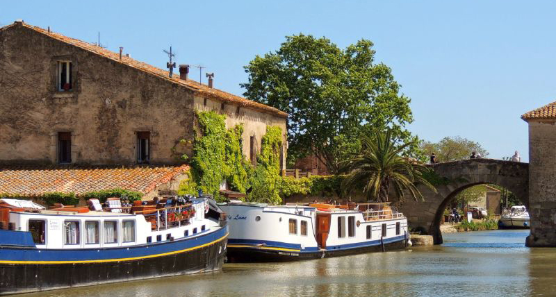 Two barges moored in Le Someil by the pretty bridge.