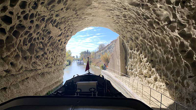 French Hotel Barge Anjodi exiting the Malpas Tunnel on the Canal du Midi. Photo: ew
