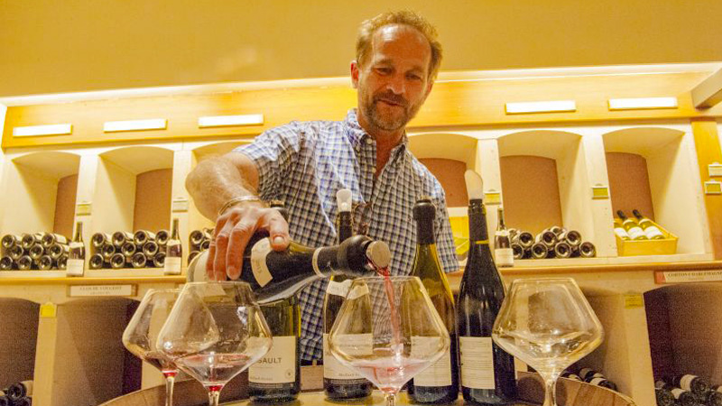 Alsace-Lorraine Wine tasting. Man pouring wine for a tasting. EW