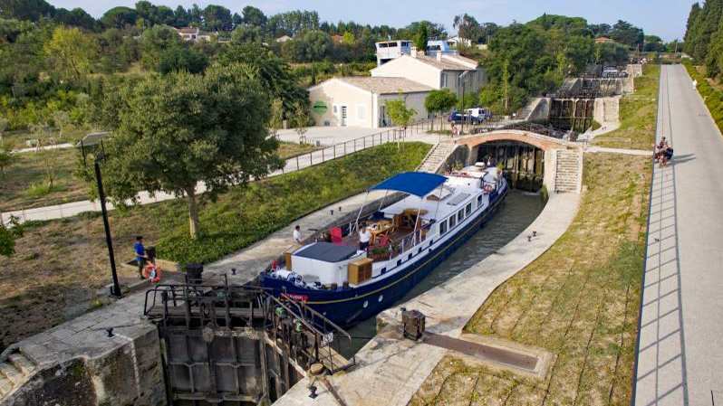 Hotel Barge Anjodi traversing the Fonserannes Lock with its 8 oval chambers and 9 gates - Canal du Midi